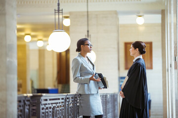 Judge and lawyer talking in courthouse