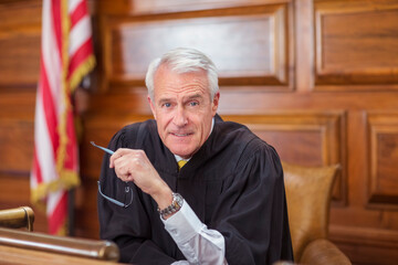 Wall Mural - Judge sitting at judges bench in court