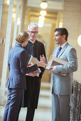 Wall Mural - Judge and lawyers talking in courthouse