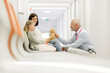 © KOTO - Doctor with teddy bear talking to girl patient in clinic corridor