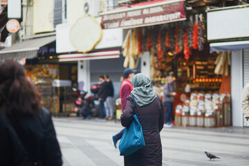 Turkish woman with head covered going shopping on a street market in Uskudar district on Asian side of Istanbul, Turkey