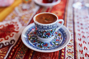 Turkish coffee served served in colorful decorated cup in cafe or restaurant in Istanbul, Turkey