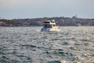 Wall Mural - Passenger ferry sails across Bosphorus strait in Istanbul, Turkey