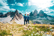 © Michael - Young athletic couple enjoys summit of Sasso di Sesto in the afternoon. Tre Cime, Dolomites, South Tirol, Italy, Europe.