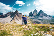 Young athletic couple enjoys summit of Sasso di Sesto in the afternoon. Tre Cime, Dolomites, South Tirol, Italy, Europe.