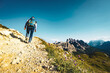 © Michael - Young sportive woman walks along scenic Dolomites high trail in the evening. Tre Cime, Dolomites, South Tirol, Italy, Europe.