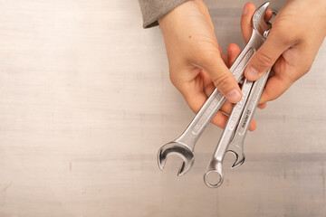 Sticker -  Wrench in hand closeup on white background