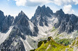 © Michael - Man enjoys Cadini di Misurina mountain range from epic view point in the morning. Tre Cime, Dolomites, South Tirol, Italy, Europe.
