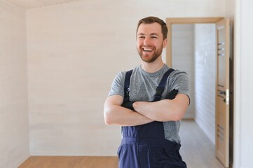 Wall Mural - Portrait of a construction worker or repairman in the house.