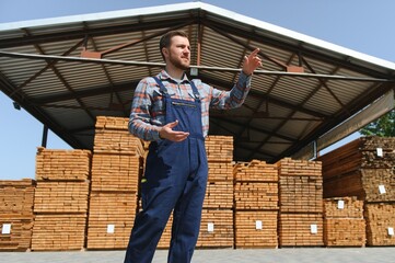 Wall Mural - Carpenter in uniform check boards on sawmill