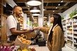 © ADDICTIVE STOCK - Customer paying with credit card in shop