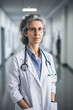 © ADDICTIVE STOCK - Generative AI illustration of senior female doctor in uniform and eyeglasses with stethoscope looking at camera while standing in passage of clinic