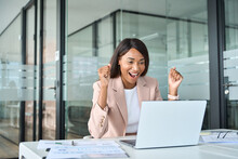 Excited Successful Young African American Business Woman Winner Executive Looking At Laptop Computer Celebrating Financial Goals Achievement, Happy About Good Professional Work Results In Office.