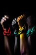 © ADDICTIVE STOCK - Generative AI illustration of raised clench fist of group of black people with colored chain on wrists protesting for rights on green background
