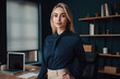 © ADDICTIVE STOCK - Generative AI illustration of young blond haired woman entrepreneur in elegant outfit looking at camera and standing against workspace