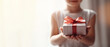 Festive greeting with a gift box in the hands of a child close-up without a face. AI generated