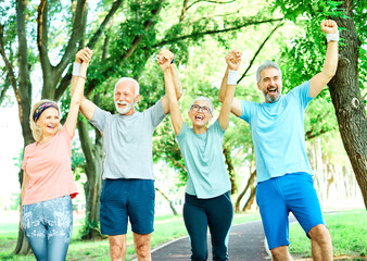 Wall Mural - outdoor senior fitness woman man lifestyle active sport exercise healthy fit retirement teamwork together holding hands