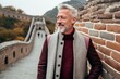 © Anne Schaum - Portrait of a smiling senior man standing on the Great Wall in China