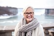 © Leon Waltz - Portrait of a happy senior woman wearing scarf and glasses outdoors in winter