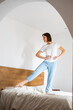 © Anna - overjoyed girl in pijamas jumping on the bed
