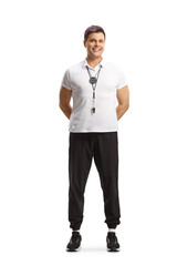 Canvas Print - Full length portrait of a sports coach with a whistle posing and smiling