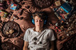 Teenager eats chocolate and listens to music with headphones. Generative AI