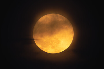 Wall Mural - super strawberry moon, reddish full moon on a summer night. full moon with clouds ahead