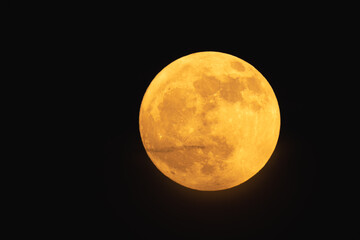 Wall Mural - super strawberry moon, reddish full moon on a summer night. full moon with clouds ahead