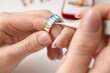 © Pixel-Shot - Female jeweler making ring on white table, closeup