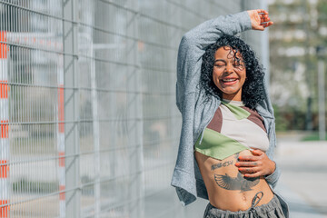 portrait of latin american urban girl dancing in the street