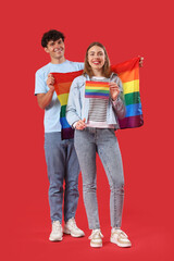  Young couple with LGBT flags on red background