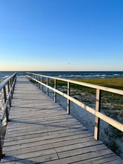  Wooden walkway to the sea, promenade to the blue sea