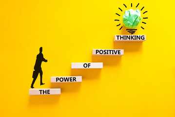Wall Mural - Positive thinking symbol. Concept words The power of positive thinking on wooden block. Beautiful yellow background. Businessman icon. Business, motivational positive thinking concept. Copy space.