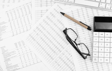 Canvas Print - Calculator, keyboard and eyeglasses lying on financial statement . Financial concept.