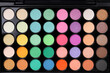 Beautiful eyeshadow palette as background, top view. Professional cosmetic product