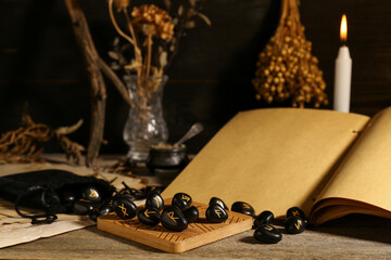 Poster - Composition with black rune stones and old book on wooden table