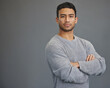 © Delcio Fernandes/peopleimages.com - Portrait of man with mockup, arms crossed and serious on studio backdrop in confident casual fashion promo. Relax, confidence and face of male on grey background with focus, pride and mock up space.