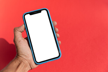 black male hand holding a smart phone isolated blank screen red background