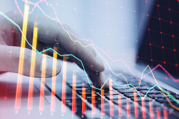 Wall Mural - Close up of hand using laptop keyboard with downward red crisis chart grid on blurry background. Recession and economic fall concept. Double exposure.