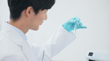 Aufkleber - Researcher looking at test tube.