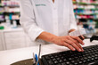 © alphaspirit - Woman at the checkout in a pharmacy to sell a drug