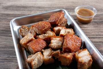 A view of a tray of deep fried pork belly chunks.