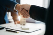 © NINENII - Close up two men shake hands at office negotiations. Making deal sign, conclude contract, formal greeting, strike bargain. Successful negotiations, insurance home loan concept.