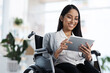 © Felix/peopleimages.com - Happy, reading and woman with a disability and a tablet for graphic design in the office. Smile, creative and a website designer in a wheelchair with technology for web and business analysis