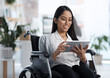 © Felix/peopleimages.com - Email, reading and woman with a disability and a tablet for communication and graphic design. Smile, creative and a website designer in a wheelchair with technology for web and software analysis
