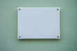 White glass nameplate on spacer metal holders mounted on office building wall outside. Clear printing board for branding with mockup space.