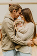 © Oksana - Young mother and father with their little daughter hugging and kissing near the trailer.