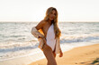 © Svetlana Sokolova - Seductive  blond woman in sexy swimwear posing on the beach in sunset light. Prtfect wavy hairs, tan skim body. Summer tropical mood.