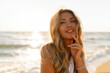 © Svetlana Sokolova - Close up portrait of beautiful blond woman in sexy swimwear posing on the beach in sunset light. Prtfect wavy hairs, tan skim body. Summer tropical mood.