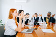 © jaimelafrickmartial  - A group of interracial business people in yoga pose in the office.